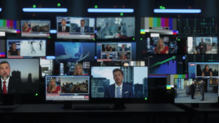 Background with Technological Multi-Screen Wall with TV Sets and Computer Displays Playing Different News Channels, Reporting on Different Topics. Playback Concept with Soft Focus Image.