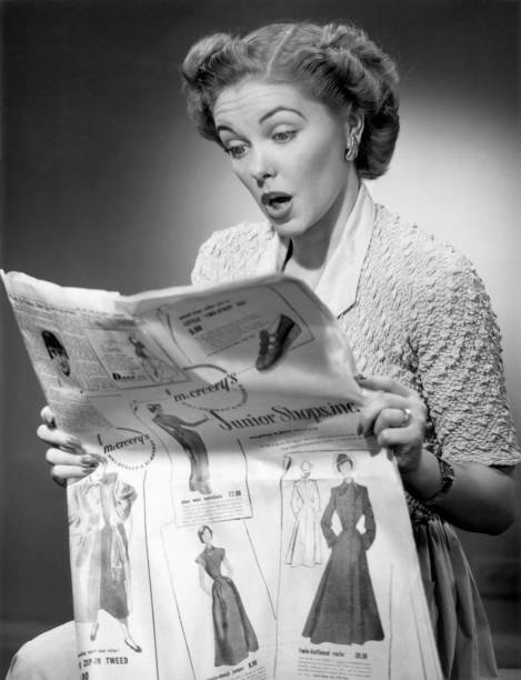 Woman reading newspaper with look of surprise