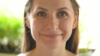 Portrait of an adult woman looking at the frame and smiling